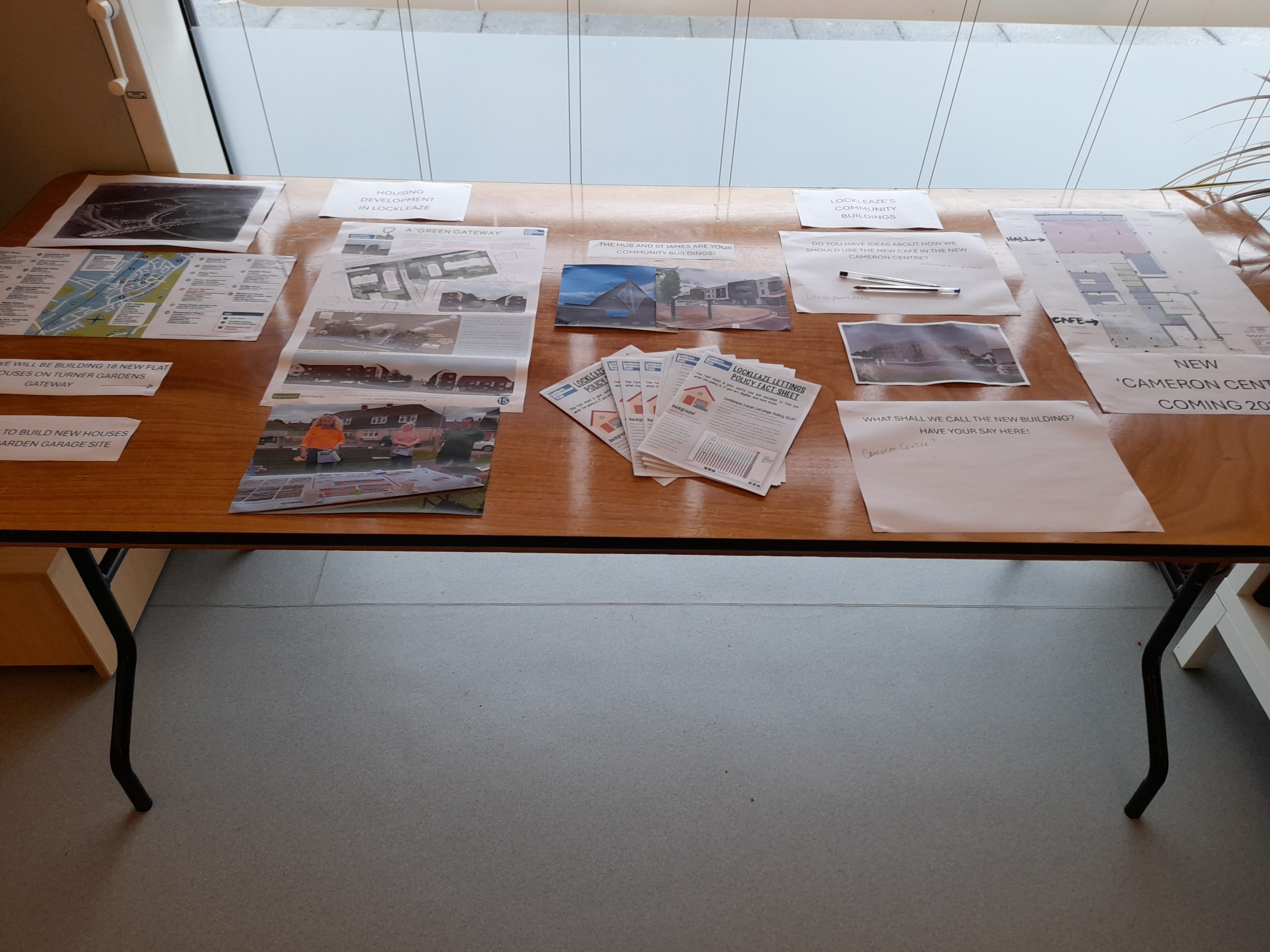 papers on a table detailing info about the new cameron centre design, old st james church and community led housing