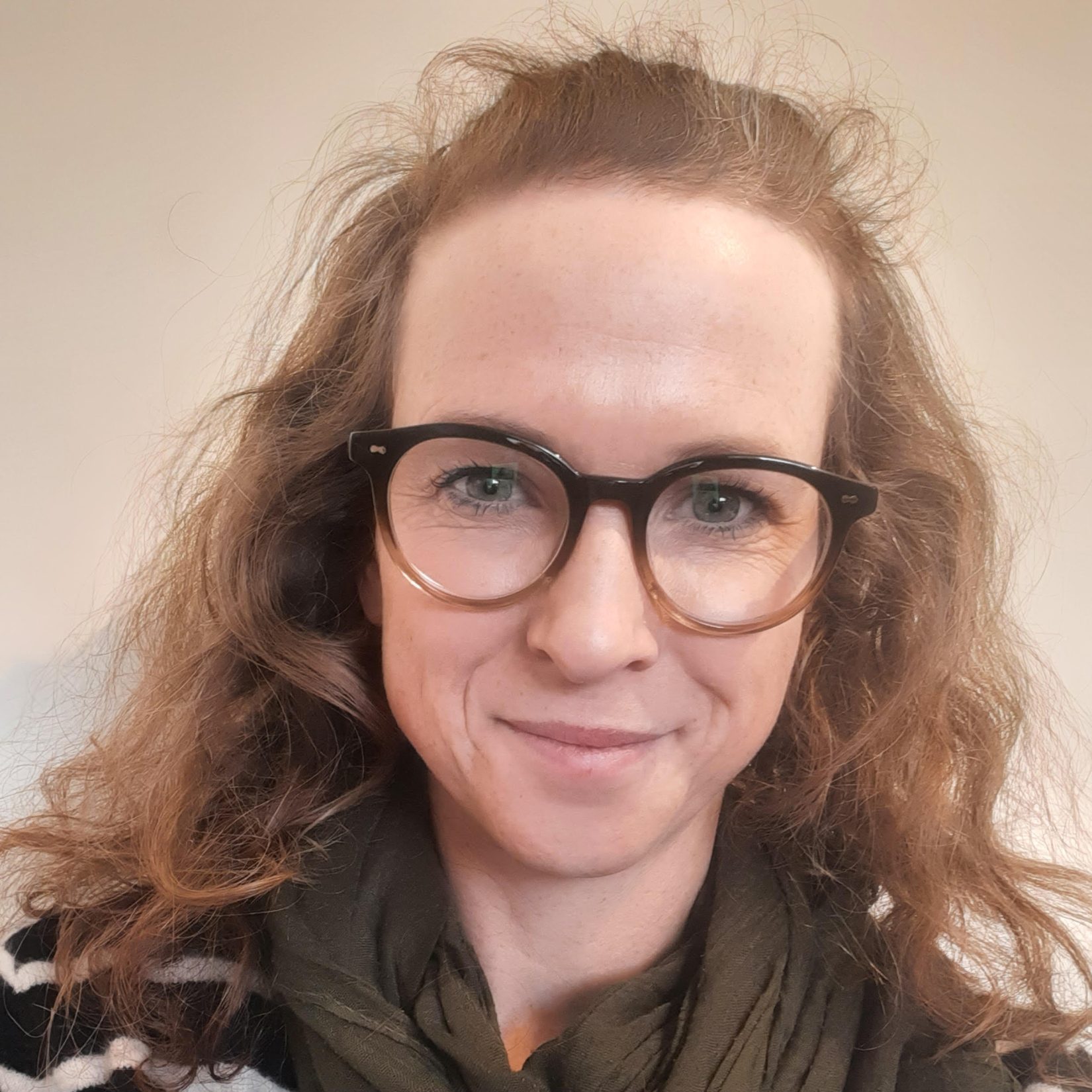 A white woman with glasses and brown hair