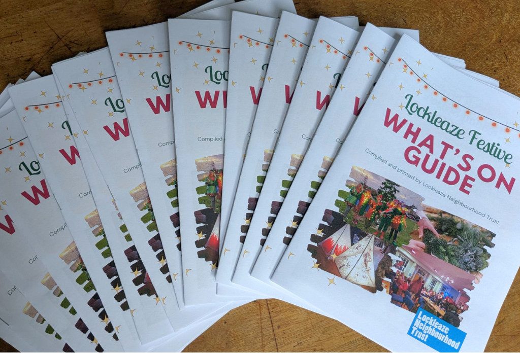 copies of the lockleaze festive whats on guide splayed on a table. it's a white a5 pamphlet with festive pictures.